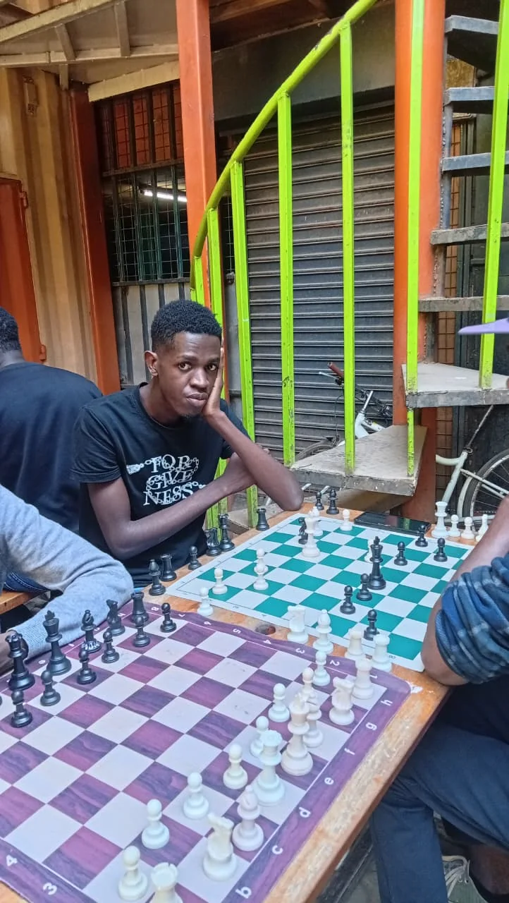 A Knight Life player considering a move at the board